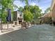 Backyard featuring a stone fireplace and patio, great for outdoor entertaining at 9622 Penshurst Trce, Charlotte, NC 28210