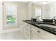 Bright bathroom featuring double sinks with granite countertops and decorative hardware at 9622 Penshurst Trce, Charlotte, NC 28210