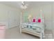 Charming bedroom with a four-poster bed, chandelier, and plenty of natural light at 9622 Penshurst Trce, Charlotte, NC 28210