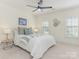 Bright bedroom with a ceiling fan, neutral decor, and natural light at 9622 Penshurst Trce, Charlotte, NC 28210