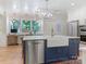Spacious kitchen island boasts a farmhouse sink, dishwasher, and stylish blue cabinetry at 9622 Penshurst Trce, Charlotte, NC 28210