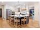 Spacious kitchen featuring a large center island with barstool seating and stainless steel appliances at 9622 Penshurst Trce, Charlotte, NC 28210