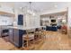 Open concept kitchen with a large island, bar stools, and an attached living room at 9622 Penshurst Trce, Charlotte, NC 28210