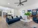 Inviting living room showcasing hardwood floors and an open layout leading to kitchen at 9622 Penshurst Trce, Charlotte, NC 28210
