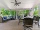 Relaxing screened porch with brick floors, comfortable seating, and a ceiling fan at 9622 Penshurst Trce, Charlotte, NC 28210