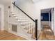 A view of a staircase with hardwood steps and a white railing leading to the upper level at 9622 Penshurst Trce, Charlotte, NC 28210
