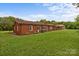 Expansive backyard featuring a well-maintained lawn and a charming brick home at 10637 Highway 52 Hwy, Rockwell, NC 28138