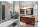 Well-lit bathroom featuring dual vanities, framed mirrors, and a decorative plant at 10637 Highway 52 Hwy, Rockwell, NC 28138