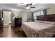 Spacious bedroom with dark wood furniture, ceiling fan, and windows providing natural light at 10637 Highway 52 Hwy, Rockwell, NC 28138