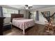 A comfortable bedroom with a large bed, dark wood furniture, and natural light from two windows at 10637 Highway 52 Hwy, Rockwell, NC 28138