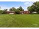 Charming brick home with a spacious front lawn and mature trees at 10637 Highway 52 Hwy, Rockwell, NC 28138