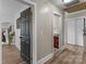 Bright hallway featuring hardwood floors and neutral walls, leading to various rooms in the home at 10637 Highway 52 Hwy, Rockwell, NC 28138