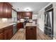 Traditional kitchen boasts wood cabinets, stainless steel appliances, and a functional center island at 10637 Highway 52 Hwy, Rockwell, NC 28138