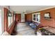 Cozy sunroom with brick walls, windows for natural light, and comfortable seating at 10637 Highway 52 Hwy, Rockwell, NC 28138