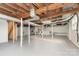 Unfinished basement with painted floors and exposed beams, presenting ample potential at 1106 S South St, Gastonia, NC 28052
