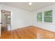 Bedroom with bright light, hardwood floors, ceiling fan, and a glimpse into an adjoining room at 1106 S South St, Gastonia, NC 28052