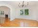 Dining room with hardwood floors, chandelier, and archway to living room at 1106 S South St, Gastonia, NC 28052