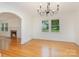Dining room with hardwood floors, chandelier, and archway to living room at 1106 S South St, Gastonia, NC 28052