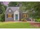 Charming gray brick home with a quaint teal front door and well-manicured lawn at 1106 S South St, Gastonia, NC 28052