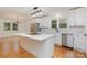 Modern kitchen with island, stainless steel appliances, white cabinets, and a view into the dining area at 1106 S South St, Gastonia, NC 28052