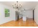 Bright kitchen with stainless steel appliances, an island with a cooktop, and a decorative chandelier at 1106 S South St, Gastonia, NC 28052