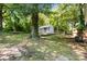 A backyard featuring a shed, mature trees, a well-maintained lawn, and the home's air conditioner at 113 W 5Th Ave, Gastonia, NC 28052