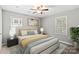 Cozy bedroom with a ceiling fan, two windows, and neutral decor at 113 W 5Th Ave, Gastonia, NC 28052