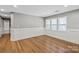 Well-lit bedroom with hardwood floors and ample natural light from large windows at 113 W 5Th Ave, Gastonia, NC 28052