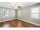 This bedroom offers hardwood floors, a ceiling fan, and ample natural light at 113 W 5Th Ave, Gastonia, NC 28052