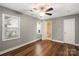Bedroom boasts hardwood floors, a ceiling fan, and a view of the en suite bathroom at 113 W 5Th Ave, Gastonia, NC 28052