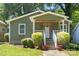 Charming bungalow home features a quaint front porch, landscaped yard, and inviting curb appeal at 113 W 5Th Ave, Gastonia, NC 28052
