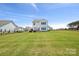 Expansive backyard with lush green grass and a secure black fence, offering privacy and ample space at 12001 Sam Snead Ct, Lancaster, SC 29720