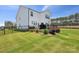 Spacious backyard featuring a patio, iron fence, and lush green lawn, perfect for outdoor living at 12001 Sam Snead Ct, Lancaster, SC 29720