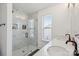 Modern bathroom with a glass-enclosed shower, dual sinks and natural light at 12001 Sam Snead Ct, Lancaster, SC 29720