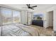 Bright bedroom featuring hardwood floors, three windows and a black dresser with TV above at 12001 Sam Snead Ct, Lancaster, SC 29720