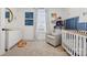 Charming Bedroom with a cozy glider, football decor, and a classic white crib at 12001 Sam Snead Ct, Lancaster, SC 29720