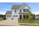 Charming two-story home featuring a three-car garage and beautifully landscaped front yard at 12001 Sam Snead Ct, Lancaster, SC 29720