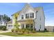 Charming white home with a three-car garage, inviting front porch, and landscaped garden at 12001 Sam Snead Ct, Lancaster, SC 29720