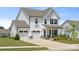 Beautiful two-story home with a three-car garage, stone accents, and a well-manicured lawn at 12001 Sam Snead Ct, Lancaster, SC 29720