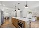 Spacious kitchen with a large island featuring seating and modern appliances, open to the living spaces at 12001 Sam Snead Ct, Lancaster, SC 29720