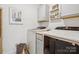 Bright laundry room featuring modern appliances, gray cabinetry, and stylish decor at 12001 Sam Snead Ct, Lancaster, SC 29720