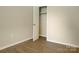 Bedroom featuring a closet, neutral walls, and light wood-look flooring at 1218 Milan Rd, Charlotte, NC 28216