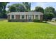 Charming brick home with well-manicured lawn and classic white shutters at 1218 Milan Rd, Charlotte, NC 28216