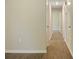 Well-lit hallway featuring neutral walls and wood flooring leading to various rooms at 1218 Milan Rd, Charlotte, NC 28216