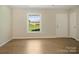Inviting living room featuring modern flooring, neutral walls, and a view to the outdoors at 1218 Milan Rd, Charlotte, NC 28216