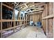 Unfinished attic space with exposed wooden beams and rafters, offering potential for customization at 124 Kristin View Ln # Townhome A, Troutman, NC 28166