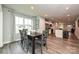 Open-concept dining room and kitchen with stainless steel appliances, island and wood-look flooring at 124 Kristin View Ln # Townhome A, Troutman, NC 28166