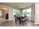 Dining room features a wood table, bench and chairs, natural light, and wood-look flooring at 124 Kristin View Ln # Townhome A, Troutman, NC 28166
