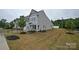 New construction townhome with grey siding, well-manicured landscaping, and a fresh green lawn at 124 Kristin View Ln # Townhome A, Troutman, NC 28166
