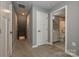 Upstairs hallway with neutral walls, carpet, and access to a full bathroom at 124 Kristin View Ln # Townhome A, Troutman, NC 28166